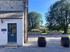 A building with a dark door and a sign reading 'West Wing Inveramie Lodge.' - Stunning Victorian 3 bedroomed house with private Fountain Garden near Inverness (Inverness)