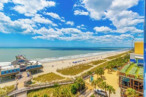 A beachside hotel with a pier, beach access, and a view of the ocean. - Yachtsman Gorgeous Oceanfront True 1br (Myrtle Beach)