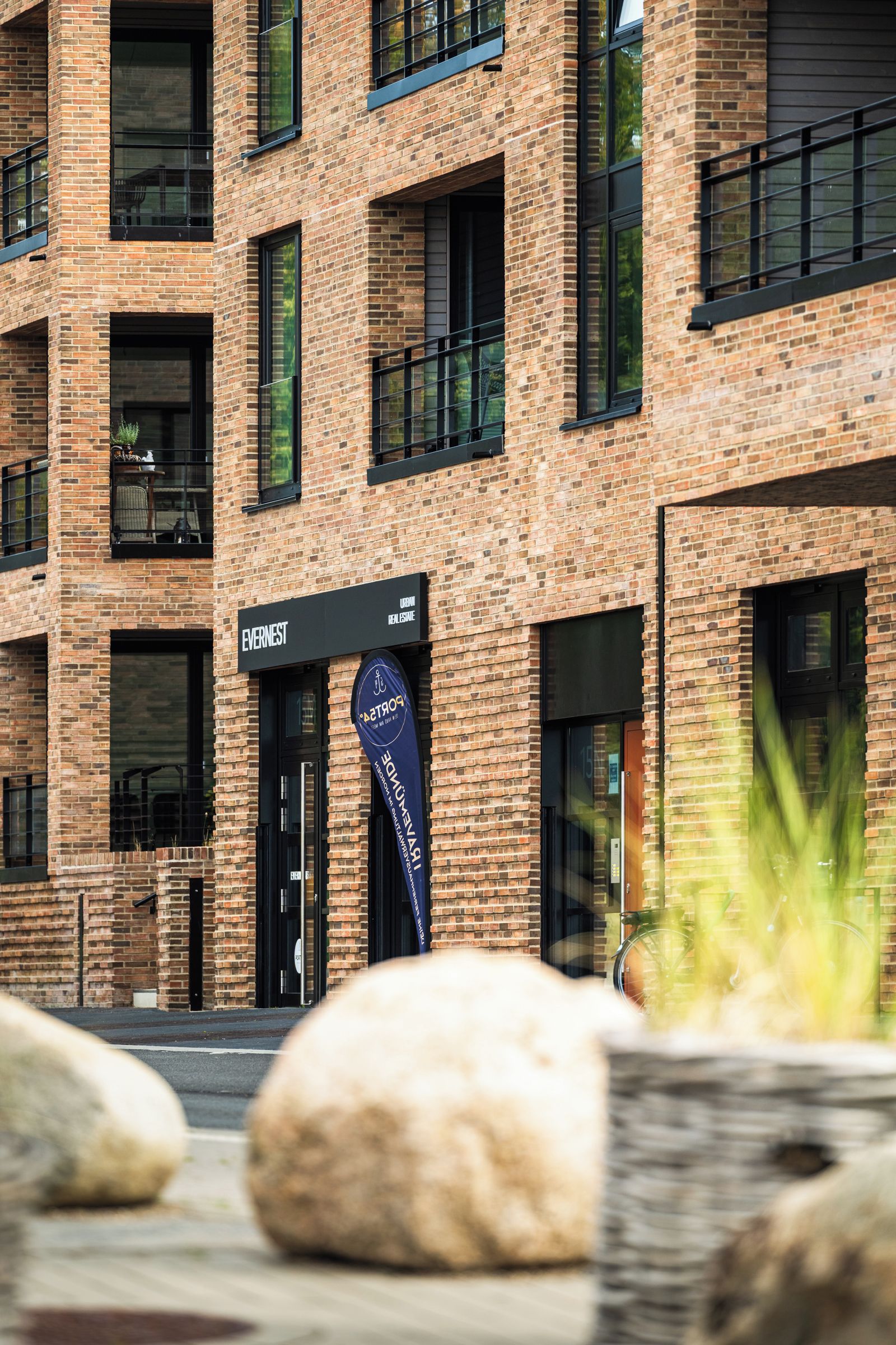 A modern brick building with multiple windows and a sign for 'Evernest'.