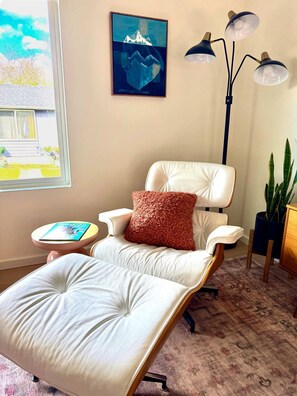 A room with a reclining chair, a small table with a book, a painting on the wall, and a floor lamp. - Extended Stay Gem in Columbia - Walk to Parks (Bellingham)