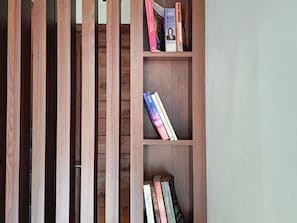 A wooden bookshelf with books.