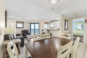 A spacious living area with a dining table, chairs, a sofa, and a kitchen in the background. - Myrtle Beach Resort RT1213 (Myrtle Beach)