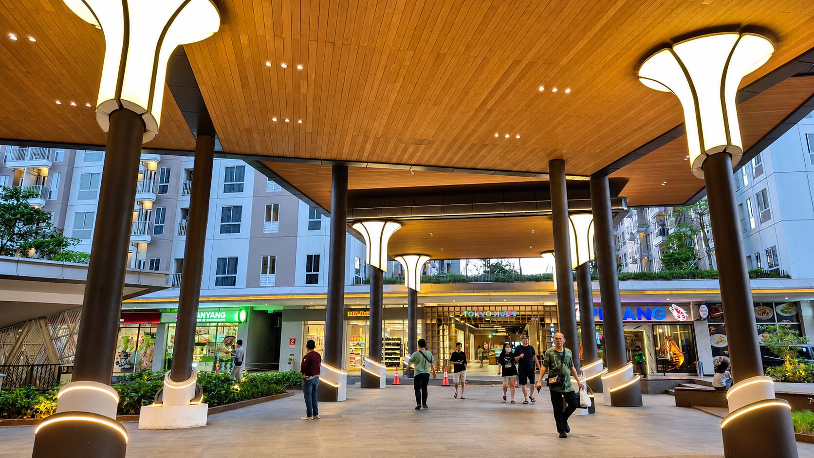 An indoor public space with a wooden ceiling, columns, and a central open area.