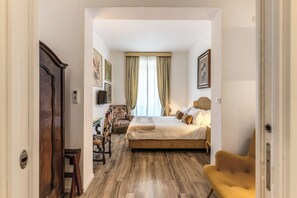 A bedroom with a bed, a chair, a desk, and a window with curtains. - BoHo Studio & Terrace (Roma)