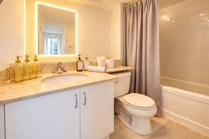 A bathroom with a sink, toilet, and shower. - Chic 2BR Suite in the Heart of Toronto's Entertainment District (Toronto)