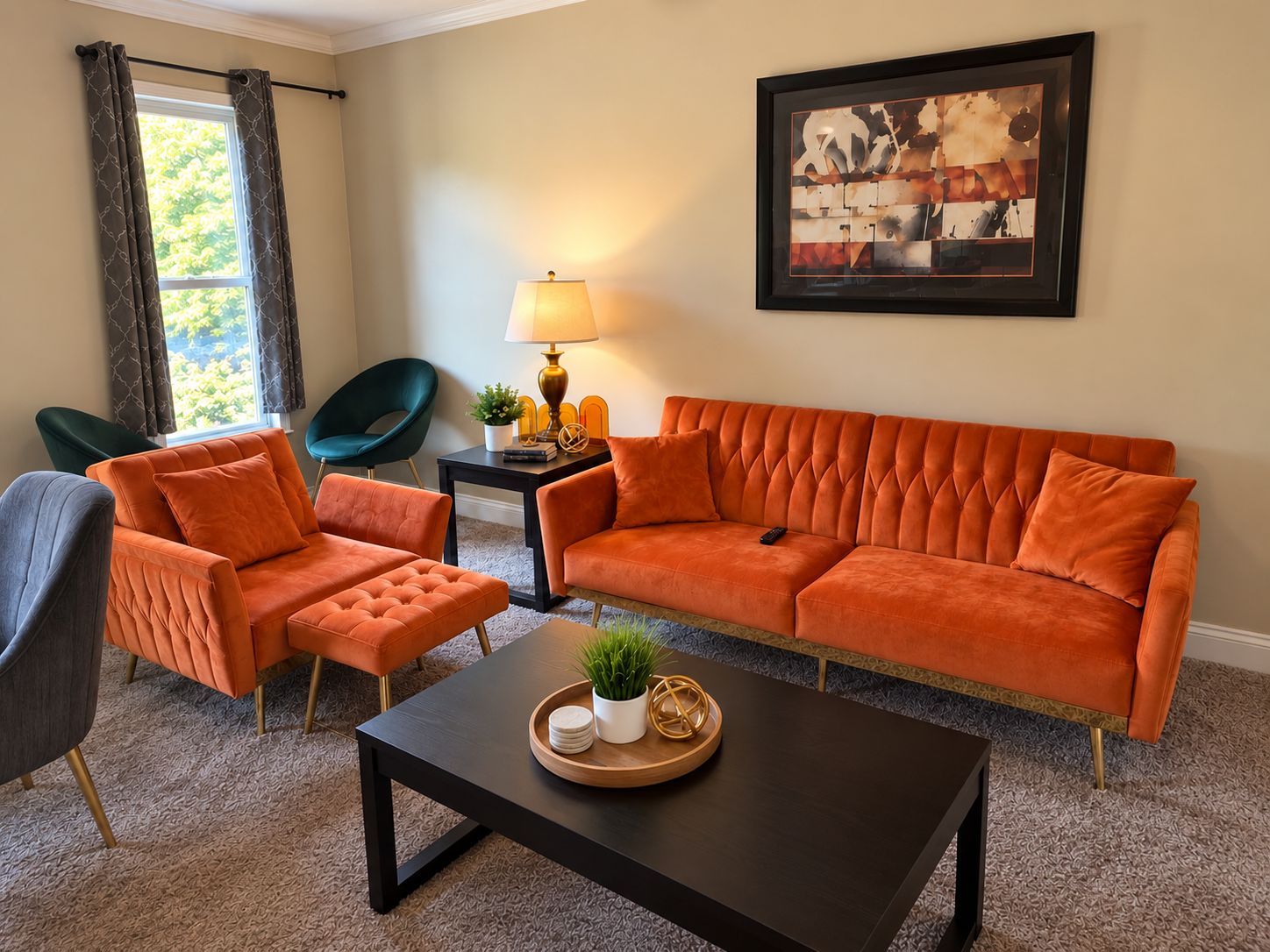 A living room with a sofa, two armchairs, a coffee table, a lamp, and a framed artwork on the wall.