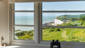 A view through a window of a coastal landscape with cliffs, a path, and a body of water. - Pip's Lookout, St Margaret's Bay (St Margaret's Bay)