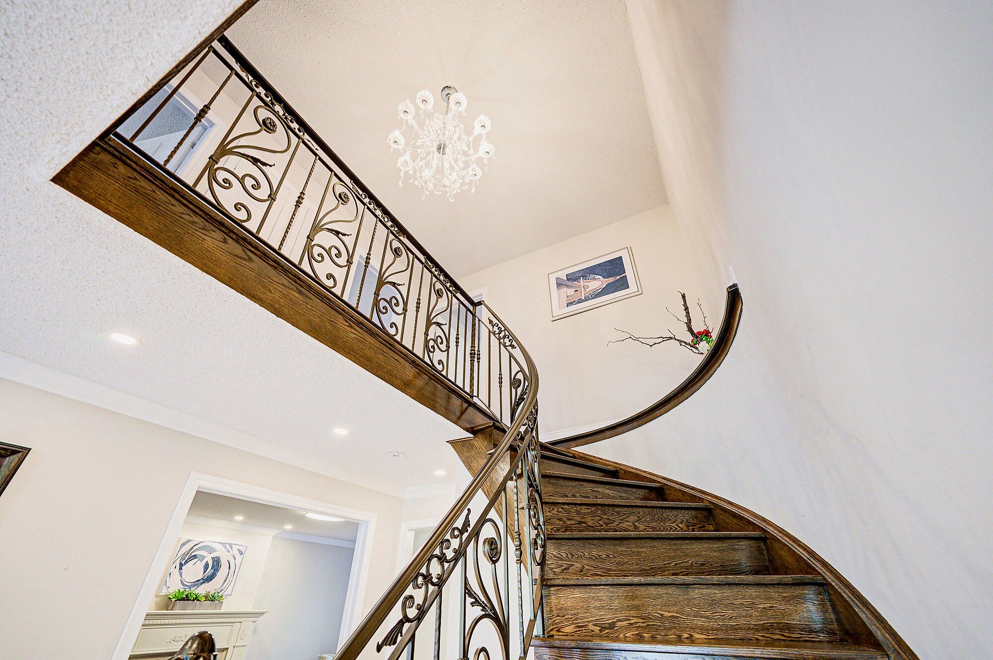 A spiral staircase with ornate metal railings and wooden steps.