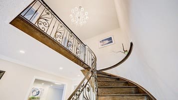 A spiral staircase with ornate metal railings and wooden steps.