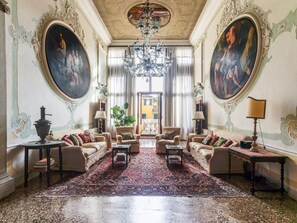 A grand room with ornate paintings, a chandelier, and a large rug. - Historic Luxury Palazzo with Private Garden & Canal Access Near St Mark's Square (Venezia)