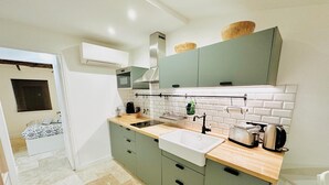 A modern kitchen with a sink, countertop, and cabinets. - 1539891003 TOWNHOUSE STUDIO 2 (Cannes)