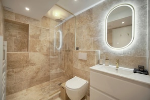 A modern bathroom with a glass-enclosed shower, a white sink, and a large mirror. - Townhouse Studio 2 Deluxe (Cannes)