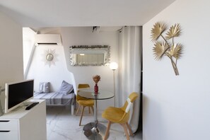 A modern living room with a sofa, a glass table, and a yellow chair. - 15014938 FRGK GOUNOD Studio Modern Air Conditioning Wi-Fi Fiber Optics (Nice)