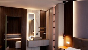 A modern hotel room with a large bed, a vanity with a mirror, a seating area, and a wardrobe. - PRESTIGE ROOM Luxury Milano  (Milan)