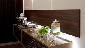 A modern bathroom with a marble vanity, a coffee machine, and a glass jar of toiletries. - PRESTIGE ROOM Luxury Milano  (Milan)