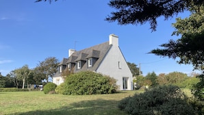 A large house with a steeply pitched roof, multiple windows, and a well-maintained lawn. - House in Breles Near Rock Beach & Amusement Park (Breles)