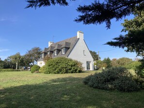A large house with a steeply pitched roof, multiple windows, and a well-maintained lawn. - House in Breles Near Rock Beach & Amusement Park (Breles)