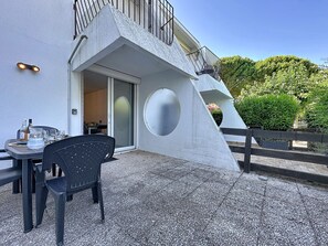 A modern building with a unique architectural design, including a sloped roof and a circular window. - Dixie Land by Interhome (La Grande Motte)