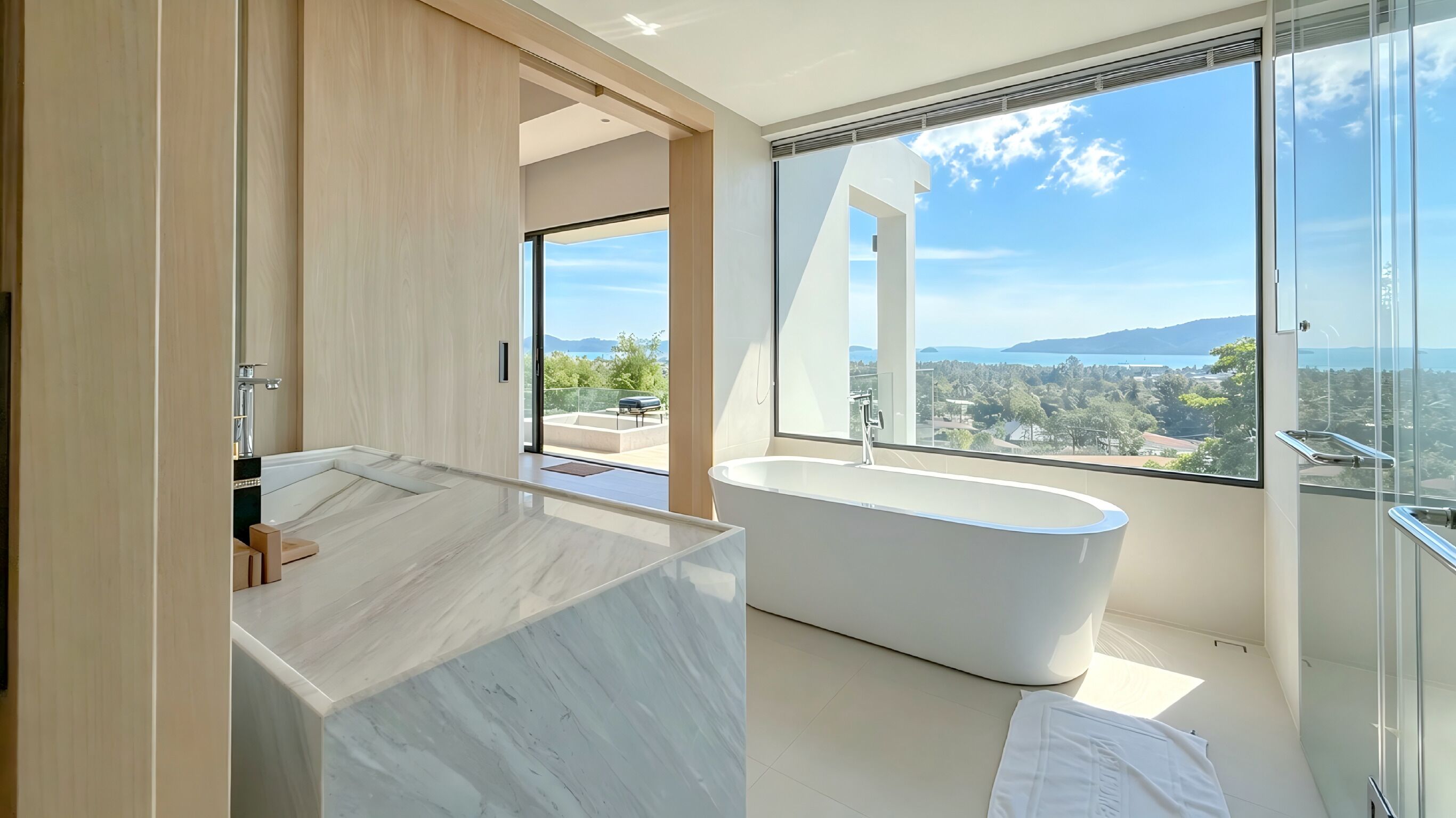 A modern bathroom with a freestanding bathtub, a large window with a view, and a marble countertop.