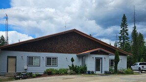 A single-story house with a sloped roof, a front porch, and a gravel driveway. - The Coolin Motel (Coolin)