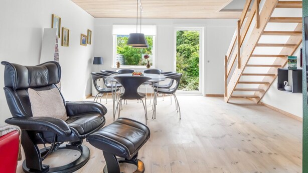 A modern living room with a dining area, a staircase, and a view of greenery. - "Lotte" - 1.5km from the sea by Interhome (Skagen)