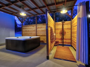 A spa area with a hot tub, wooden walls, and a shower. - Private. Luxury. River House Retreat at Yosemite. Hot Tub. Outdoor Shower. Views (Coarsegold)
