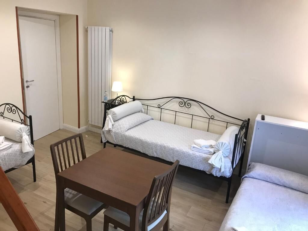 A room with a bed, a table, and a chair.