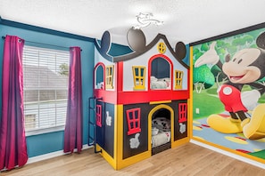 A children's playhouse with a Mickey Mouse mural, a window with curtains, and a wooden floor. - Disney Villa w/ Private Pool - 8 Mins to Disney (Kissimmee)
