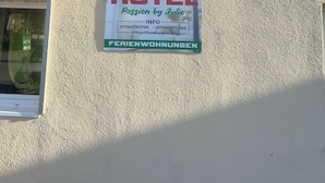 A hotel sign with 'HOTEL Passion by Julie' and 'FERIENWOHNUNGEN' on a building facade.