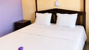 A bed with a canopy, a bedside table, and a wall-mounted light switch. - Amazing 3-bedroom house in pleasant Nosy Be perfect for relaxing getaway (nosy be)