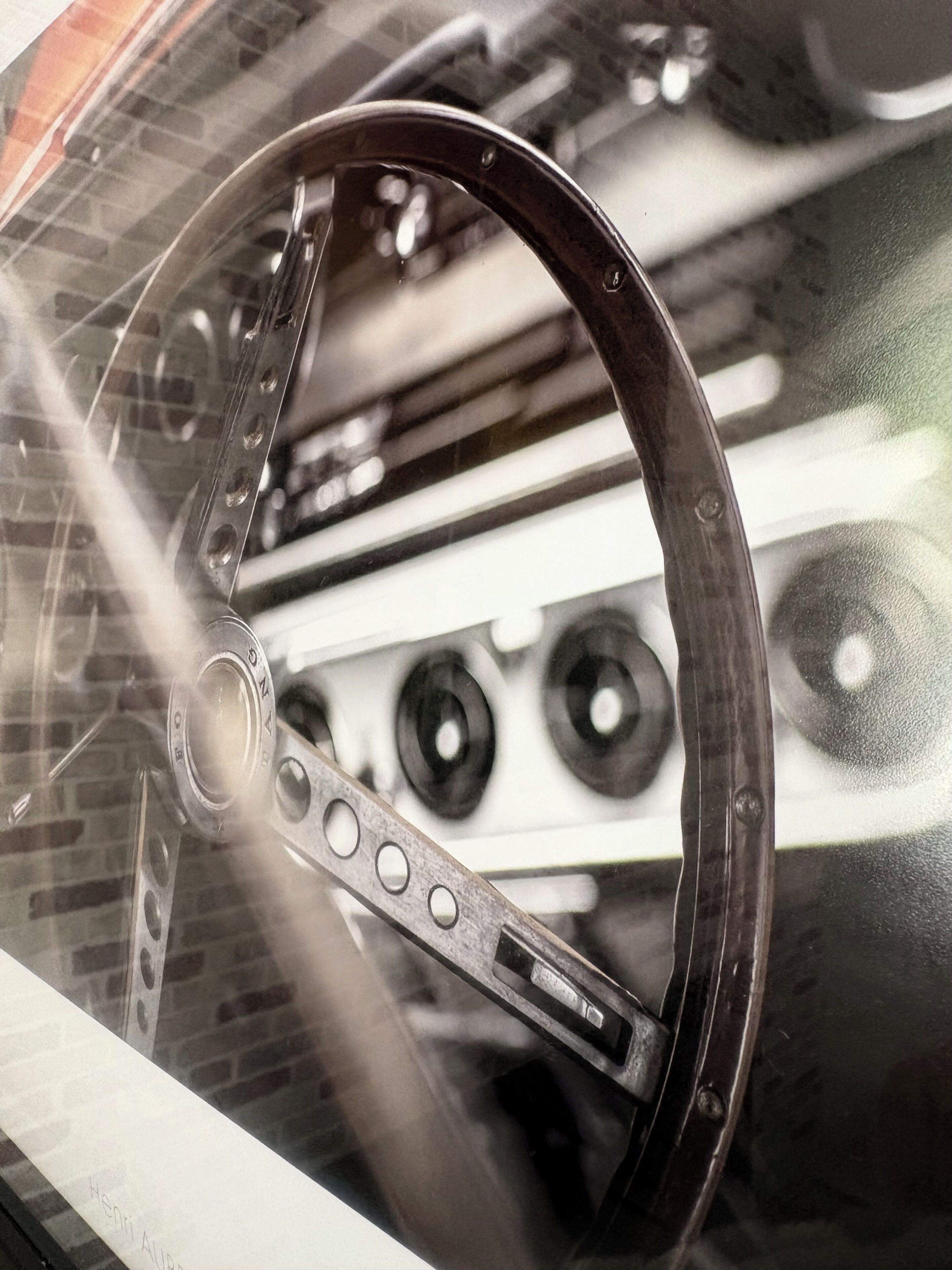 A steering wheel with a metallic rim and a central hub, likely part of a vehicle's interior.