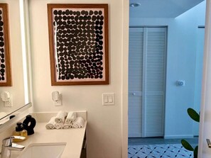 A bathroom with a mirror, towel rack, sink, and a framed artwork on the wall. - Brickell Area| Free Parking| Balcony| Rooftop Pool (Miami)