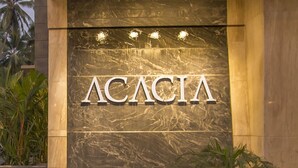A building facade with the name 'ACACIA' prominently displayed in large letters.