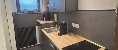 Fridge, stovetop, dishwasher, coffee/tea maker
