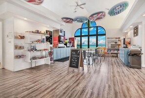 A modern interior with a pool table, shelves with various items, and a large window with a view. - Desert Bloom Basecamp - Pool, Hot Tub, Waterslide, Sleeps 10, Kid & Pet Friendly (St. George)