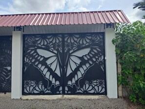 A gated entrance with a decorative metal design. - Volcano View Tropical Farmhouse! Private Farm Stay; AC near La Fortuna Waterfall (La Fortuna)