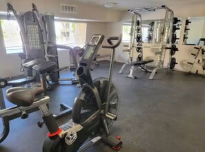 A gym with exercise equipment including a stationary bike, a treadmill, and weight machines. - 2BR/2BA Scottsdale Condo with heated pool (Scottsdale)