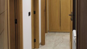 A hallway with wooden doors and a radiator. - Charming 2-bedroom Apartment in Central Tunis With Garden View (La Marsa)