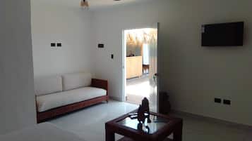 Luxury Suite, Pool View | Living area | 32-inch TV with satellite channels