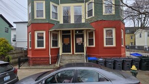 A multi-story building with a prominent corner section and a front entrance. - Ringgold (Providence)