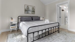 A bedroom with a bed, bedside table, lamp, and a painting on the wall. - Sleep 9 Boiling Springs SC w/2 kings, Pool Table (Boiling Springs)