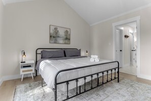 A bedroom with a bed, bedside table, lamp, and a painting on the wall. - Sleep 9 Boiling Springs SC w/2 kings, Pool Table (Boiling Springs)