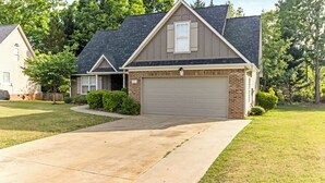 A residential house with a garage, a driveway, and a well-maintained lawn. - Sleep 9 Boiling Springs SC w/2 kings, Pool Table (Boiling Springs)