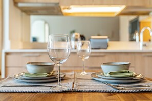 Una mesa de comedor con dos platos, una copa y un tenedor.