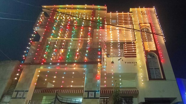 A building with a sign reading 'THAKUR 31' and multiple balconies.