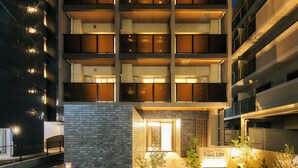 A multi-story hotel with a brick facade, a visible entrance, and a sign indicating 'Grand Stay.' - Grand STAY Hakata Nishinakasu (Fukuoka)
