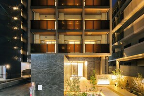 A multi-story hotel with a brick facade, a visible entrance, and a sign indicating 'Grand Stay.' - Grand STAY Hakata Nishinakasu (Fukuoka)