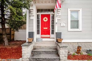 A house with a red door, stone steps, and a mailbox. - The Thomas Honeycomb Inn w/ Tiki Bar and Roof Deck (Salem)