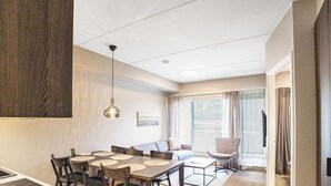 A modern kitchen with a dining area, a sofa, and a chair. - Äkäspokka by Interhome (Äkäslompolo)