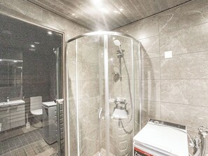 A modern bathroom with a glass-enclosed shower, a toilet, and a sink. - Äkäspokka by Interhome (Äkäslompolo)